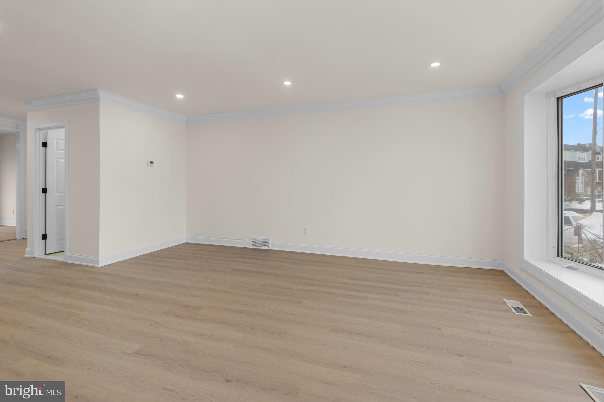 10867 Harrow Road Philadelphia, PA 19154 - Photo 2 of 19 a view of an empty room with wooden floor and a window