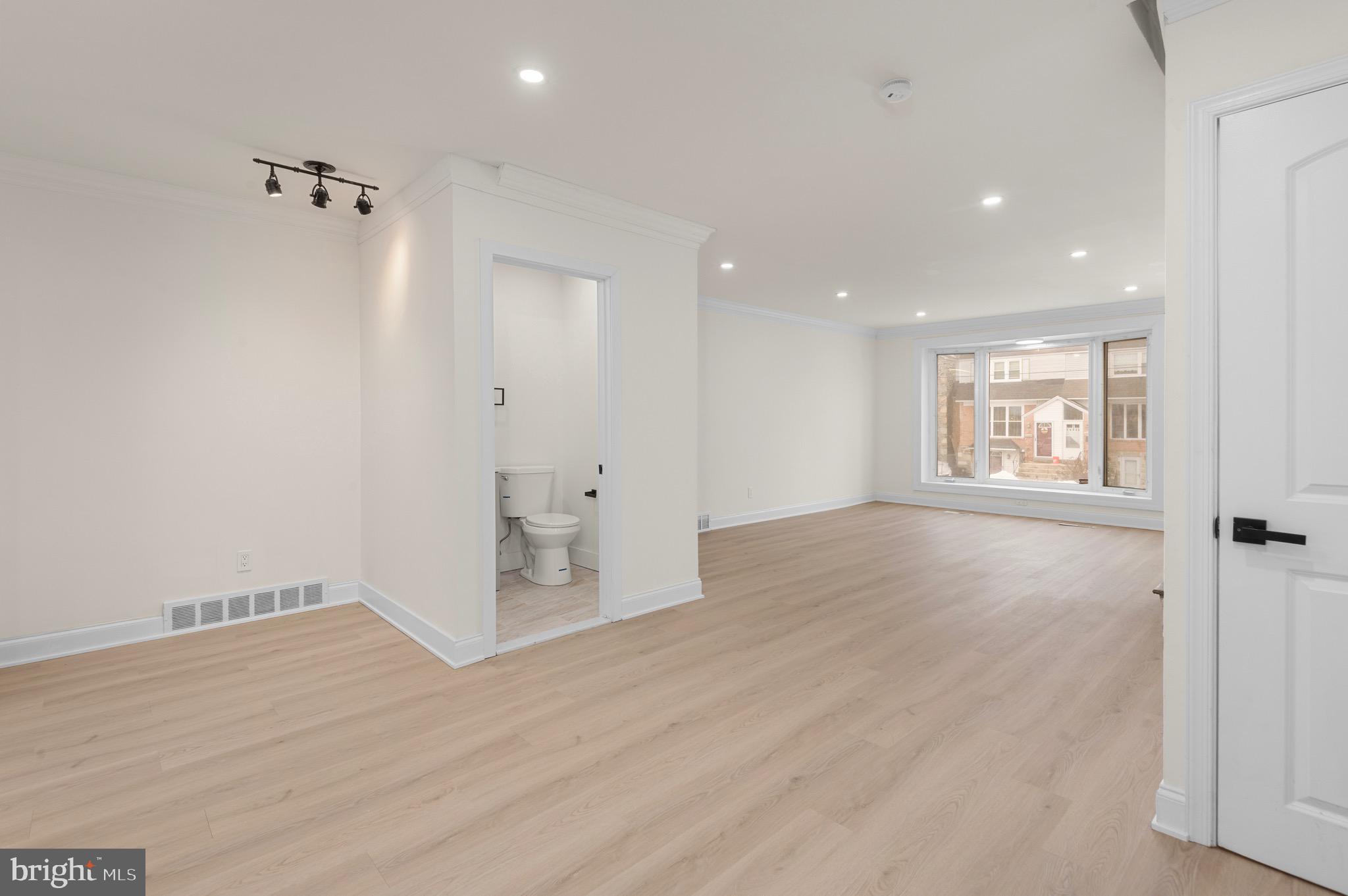 10867 Harrow Road Philadelphia, PA 19154 - Photo 7 of 19 an empty room with wooden floor and windows
