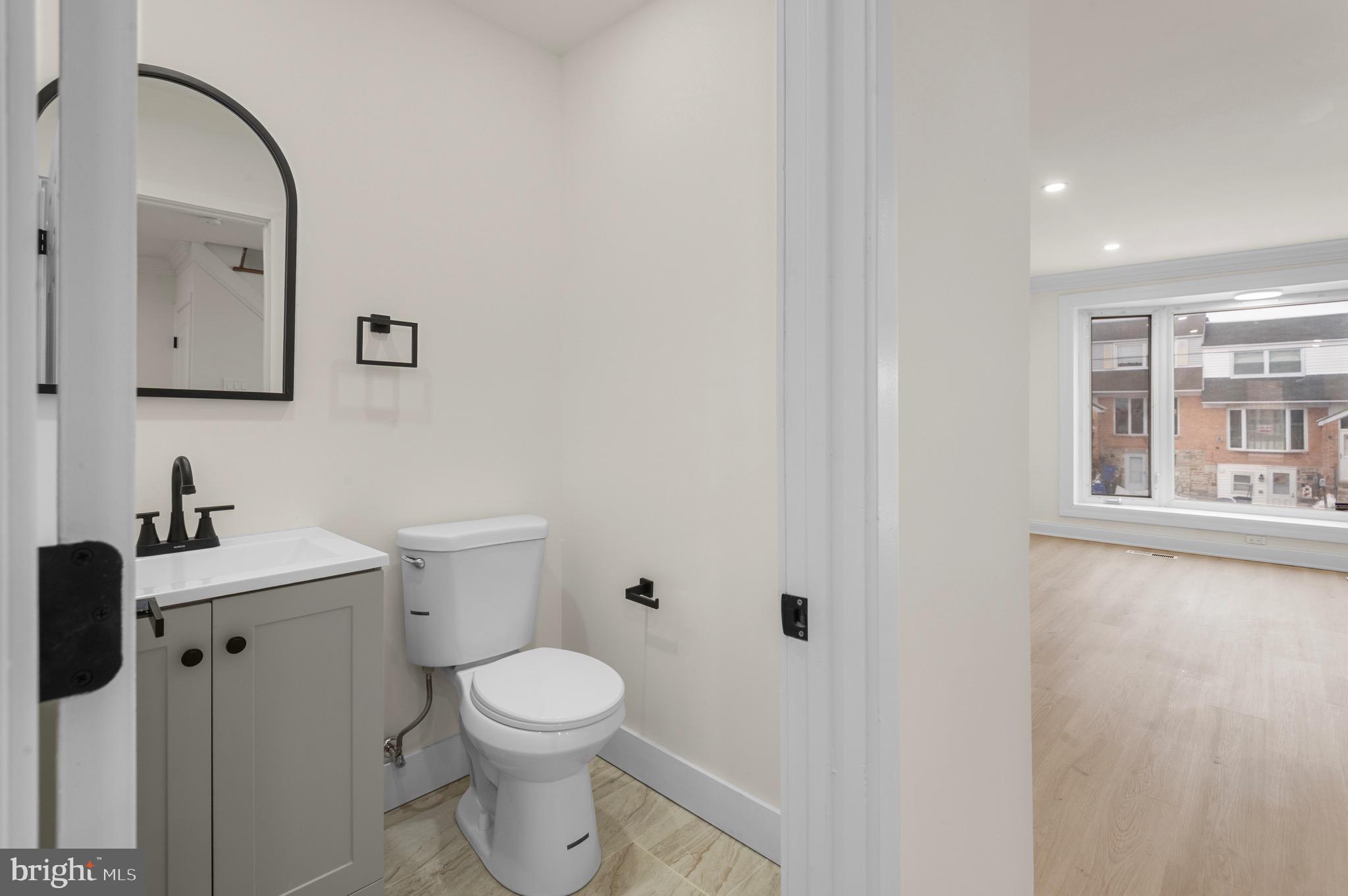 10867 Harrow Road Philadelphia, PA 19154 - Photo 8 of 19 a bathroom with a toilet a sink and mirror