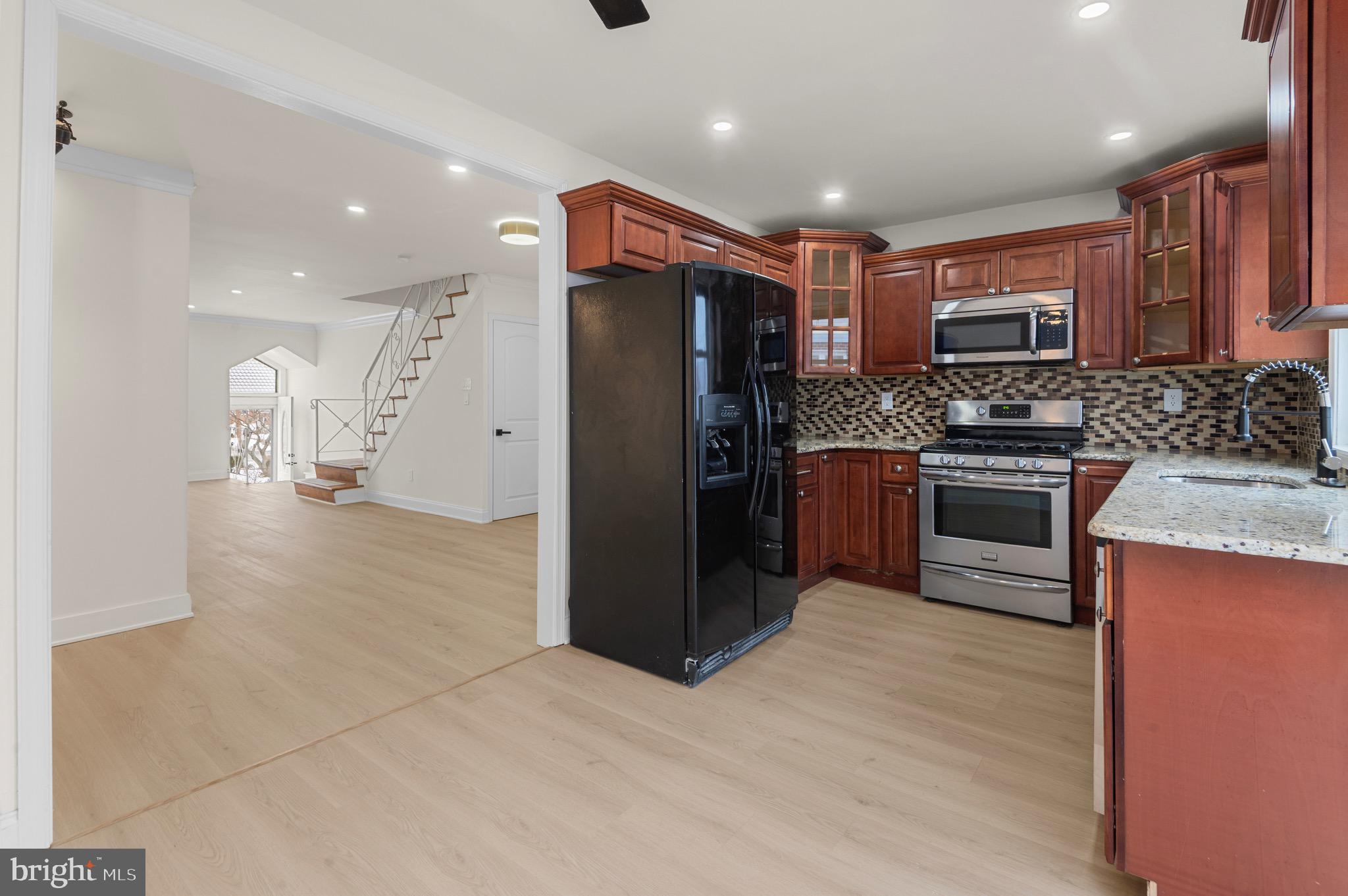 10867 Harrow Road Philadelphia, PA 19154 - Photo 9 of 19 a kitchen with stainless steel appliances granite countertop a refrigerator and a stove top oven