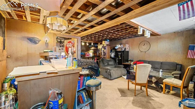 a living room with furniture a rug and a clock