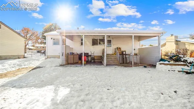 a view of a house with a yard and sitting area