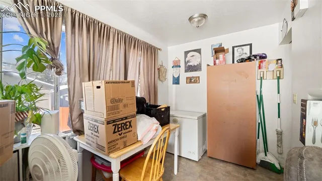 a view of living room with furniture and a window