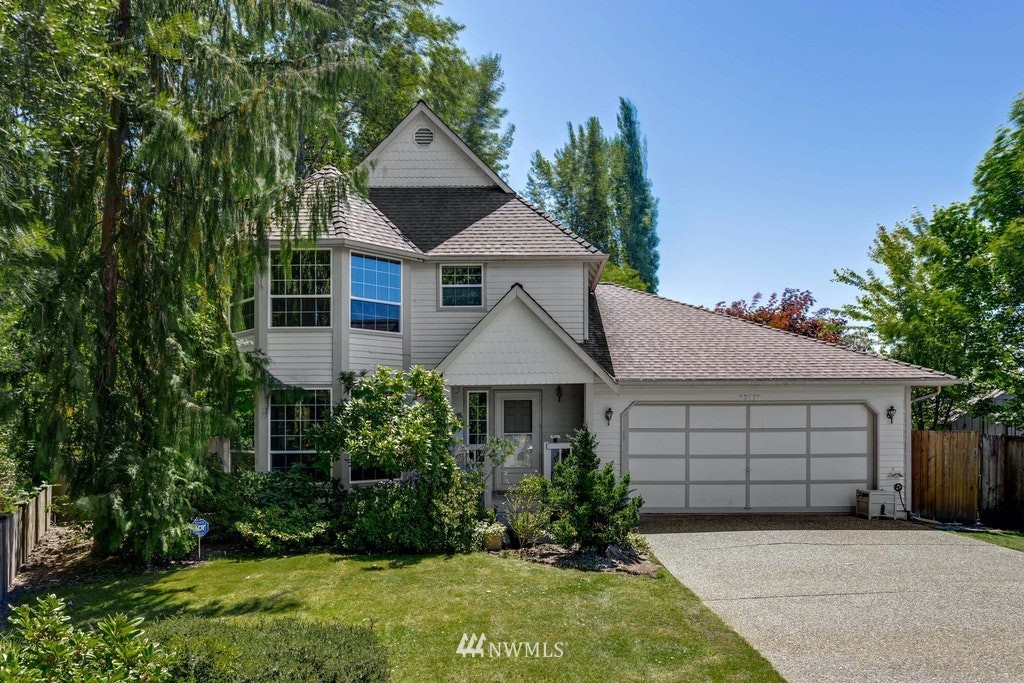 22915 13th Place West Bothell, WA 98021 - Photo 1 of 28 a front view of a house with a yard and garage