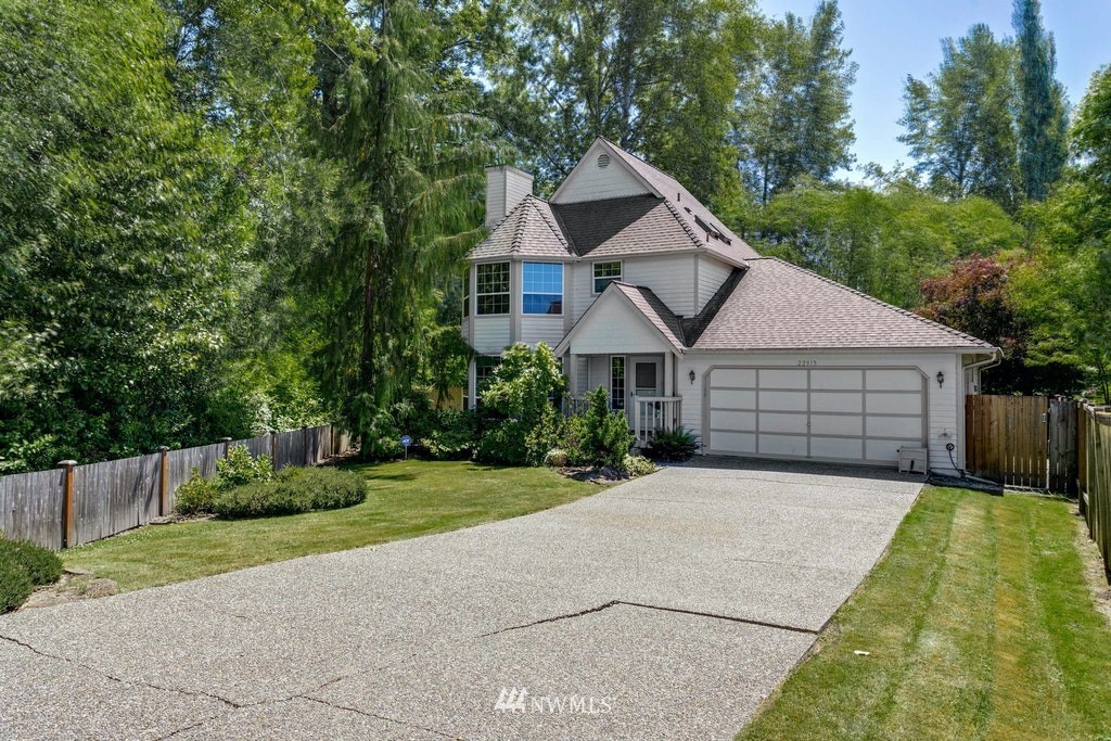 22915 13th Place West Bothell, WA 98021 - Photo 2 of 28 a front view of a house with a yard and trees
