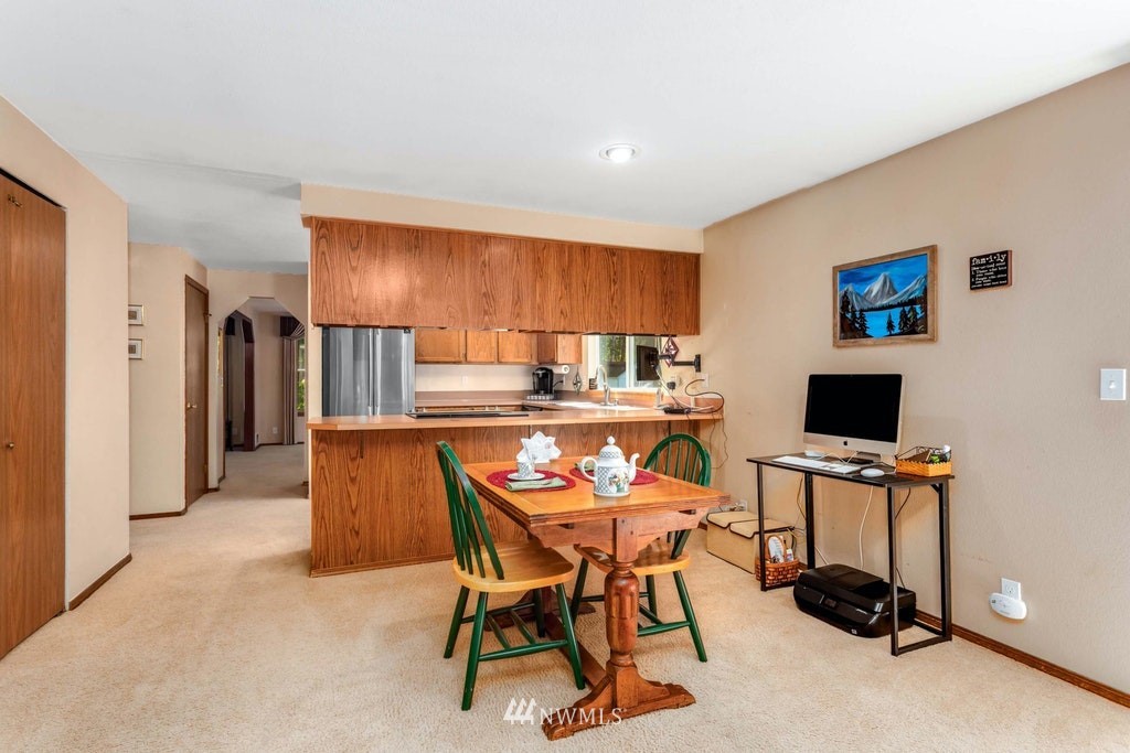 22915 13th Place West Bothell, WA 98021 - Photo 13 of 28 a dining room with furniture and a flat screen tv