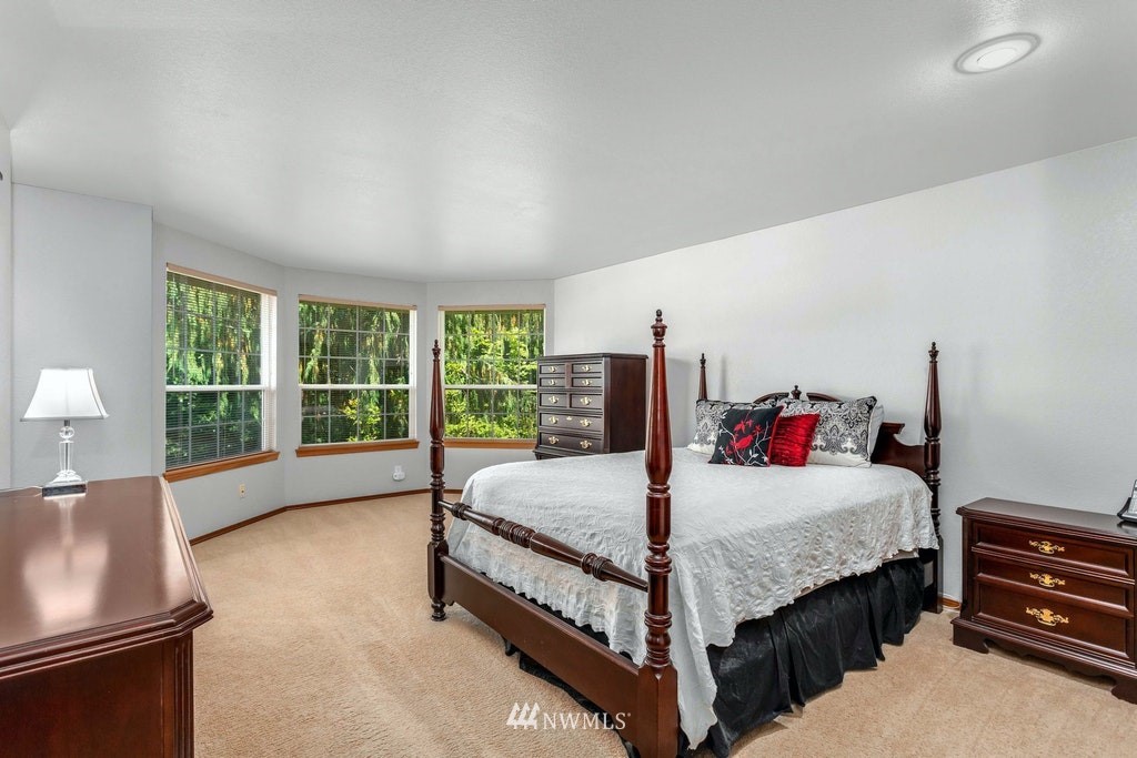 22915 13th Place West Bothell, WA 98021 - Photo 17 of 28 a bedroom with a bed and a dresser next to a window