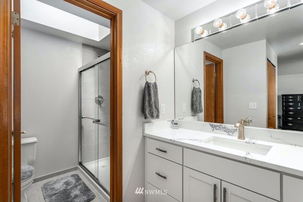 22915 13th Place West Bothell, WA 98021 - Photo 19 of 28 a en suite bathroom with a double vanity sink and a mirror