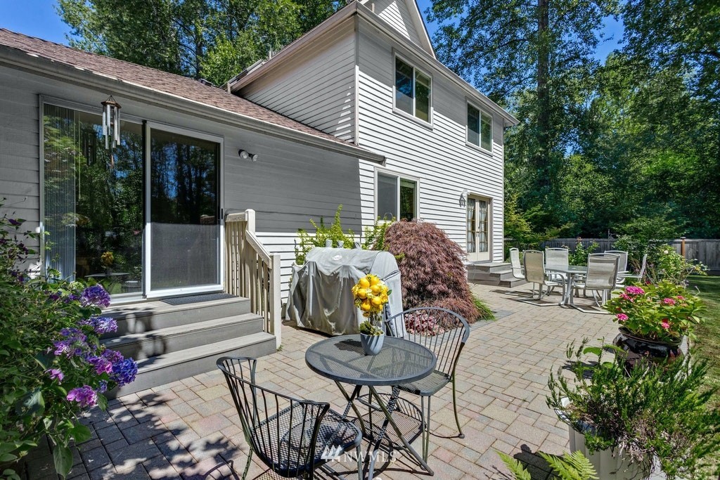 22915 13th Place West Bothell, WA 98021 - Photo 23 of 28 a view of a patio with couches table and chairs and potted plants