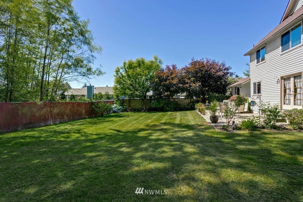 22915 13th Place West Bothell, WA 98021 - Photo 27 of 28 a garden with trees in the background