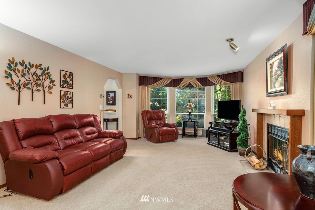 22915 13th Place West Bothell, WA 98021 - Photo 5 of 28 a living room with furniture a fireplace and a large window
