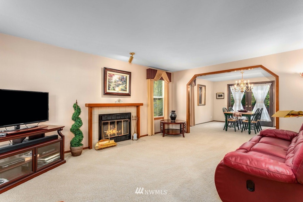 22915 13th Place West Bothell, WA 98021 - Photo 7 of 28 a living room with furniture a flat screen tv and a fireplace
