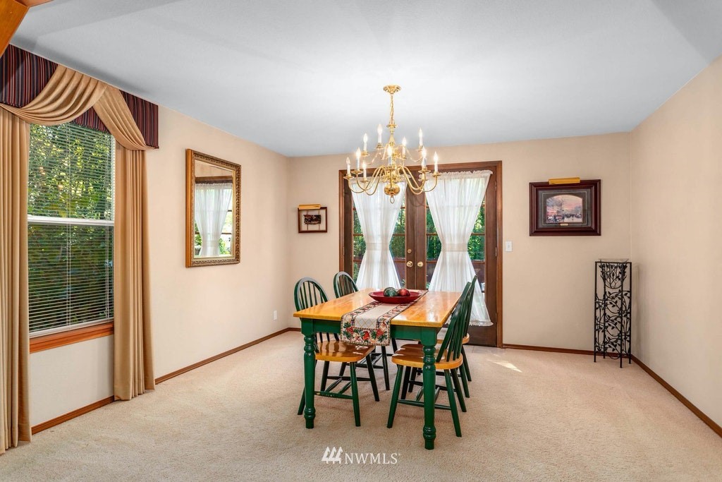 22915 13th Place West Bothell, WA 98021 - Photo 8 of 28 a view of a dining room with furniture a chandelier and a window
