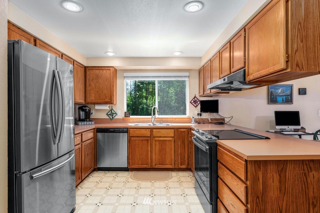22915 13th Place West Bothell, WA 98021 - Photo 10 of 28 a kitchen with stainless steel appliances granite countertop a stove a sink dishwasher a refrigerator and a microwave