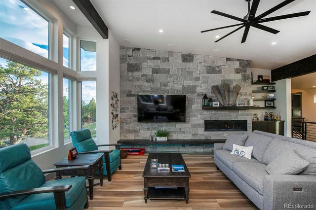 a living room with furniture a flat screen tv and a fireplace