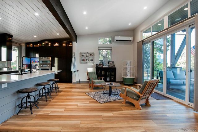 a living room with fireplace furniture and a large window