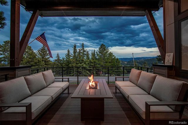 a balcony with furniture and a potted plant