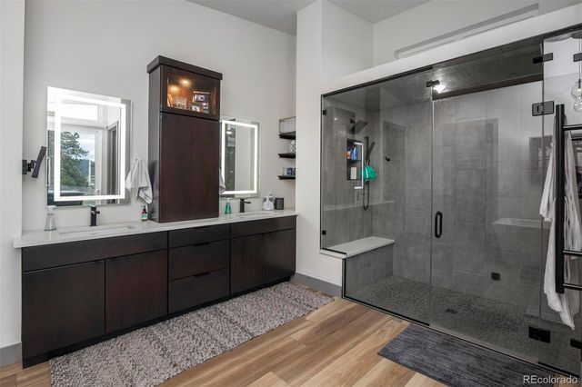 a spacious bathroom with a shower sink and mirror