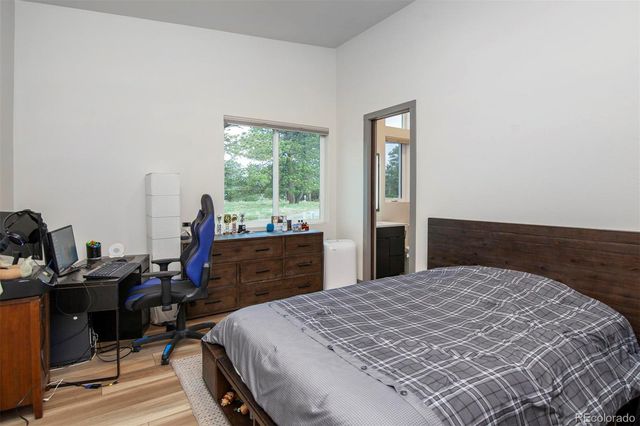 a bed sitting in a bedroom next to a window