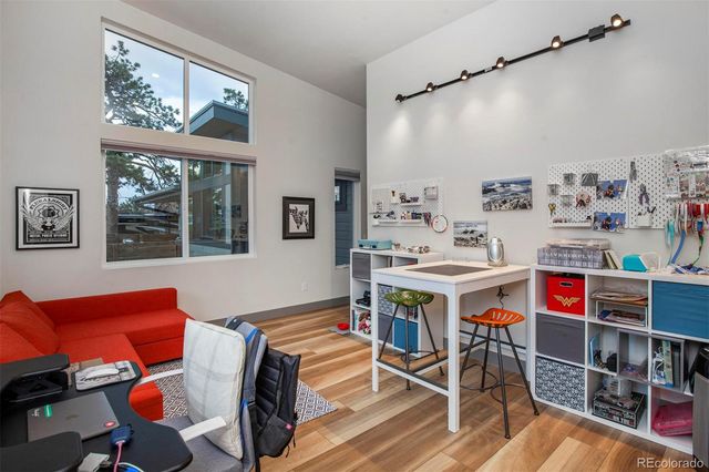 a living room with furniture a flat screen tv and a window