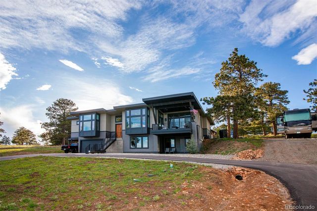a front view of a house with swimming pool garden and patio