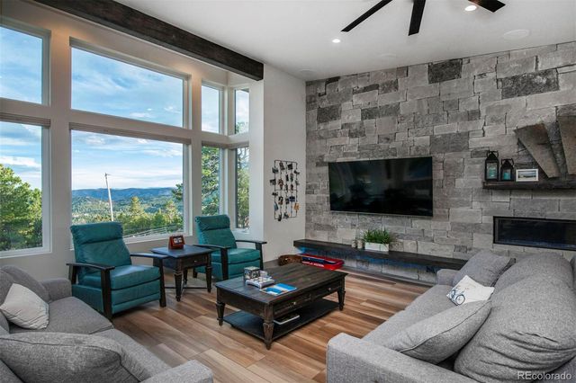 a living room with furniture a flat screen tv and a fireplace