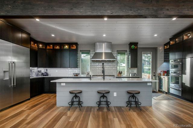 a kitchen with lots of counter top space and stainless steel appliances