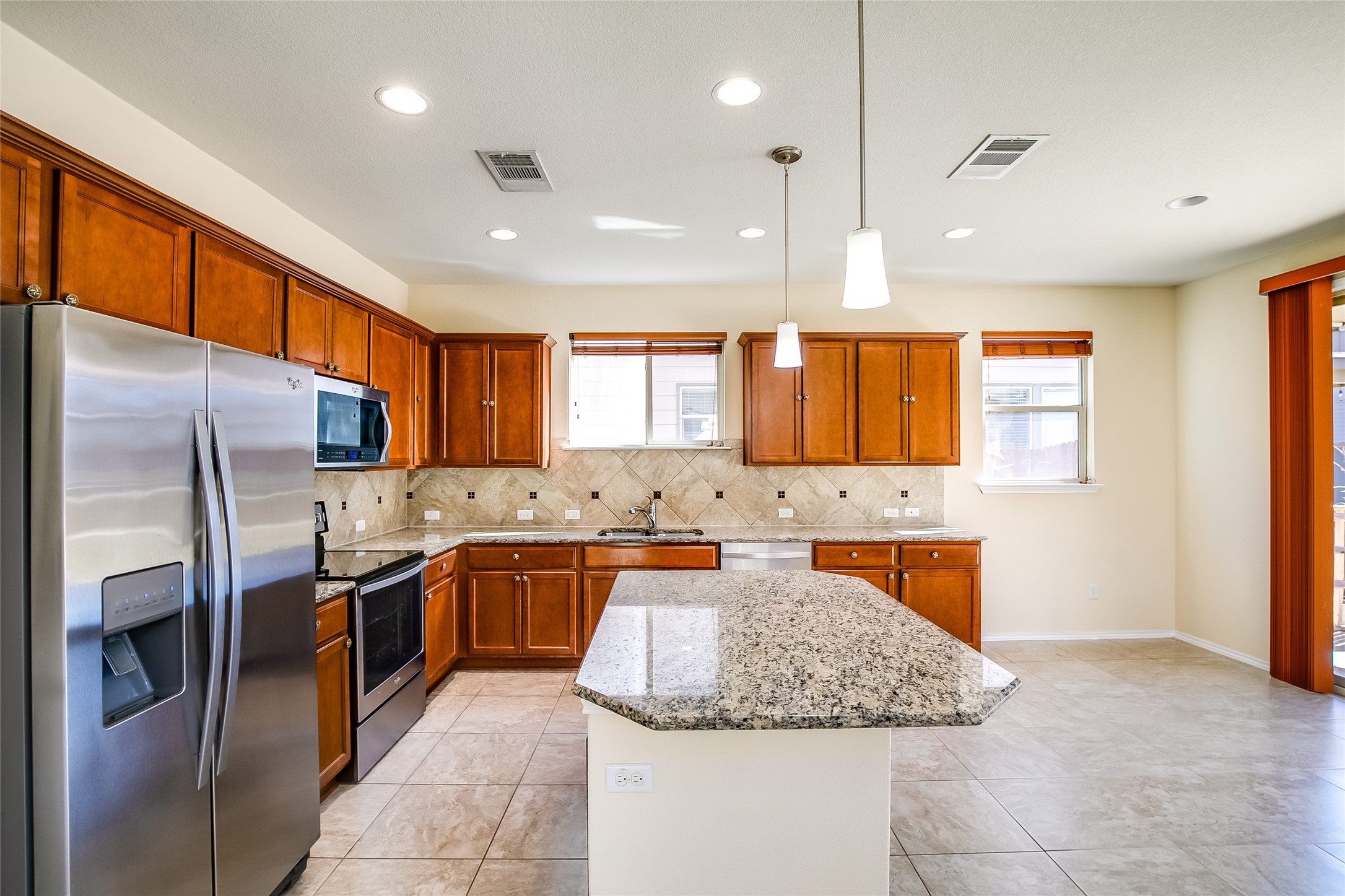 3717 Dover Ferry Crossing Austin, TX 78728 - Photo 11 of 29 a kitchen with stainless steel appliances granite countertop a sink stove and refrigerator