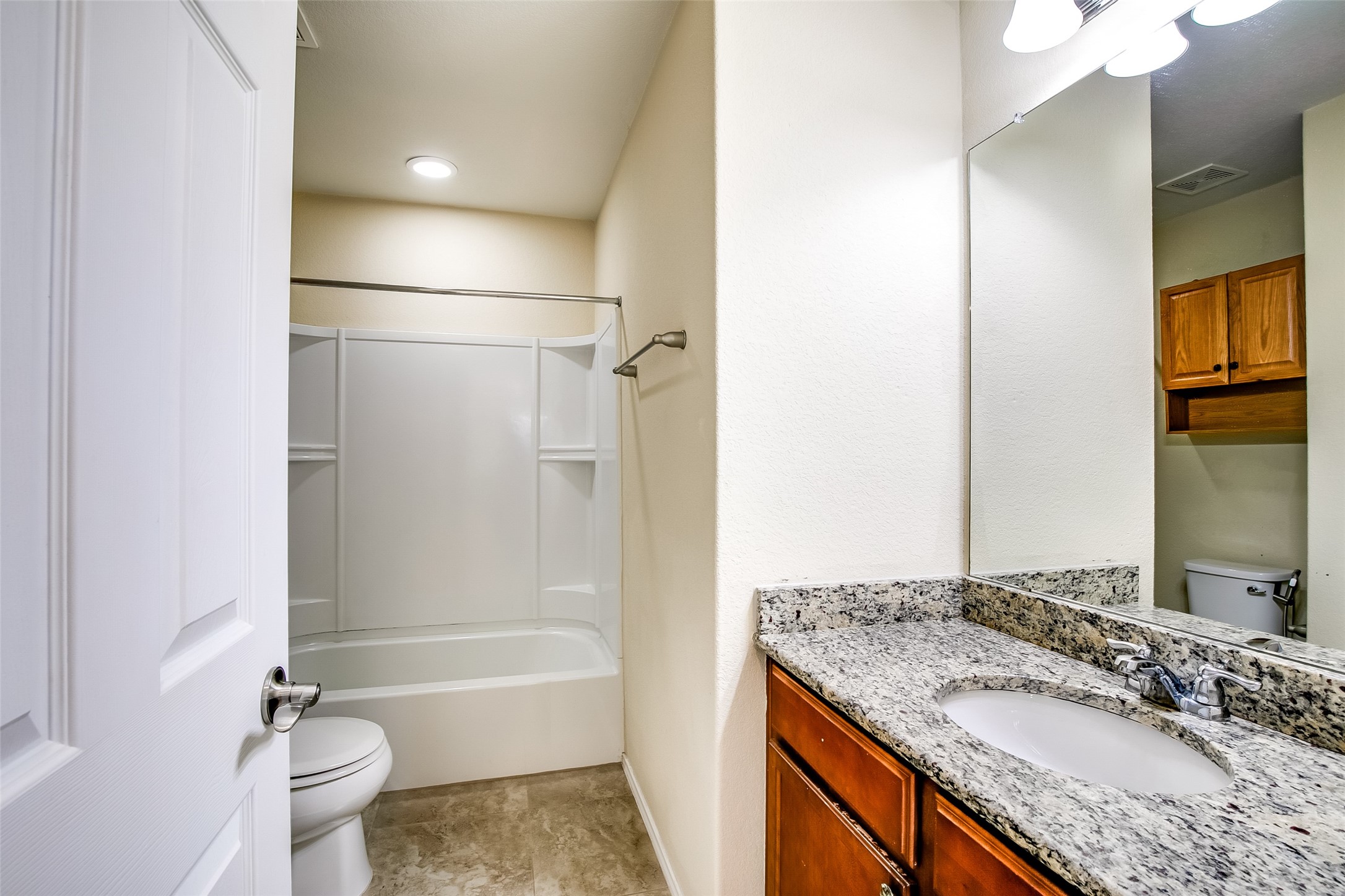 3717 Dover Ferry Crossing Austin, TX 78728 - Photo 22 of 29 a bathroom with a granite countertop sink toilet and shower
