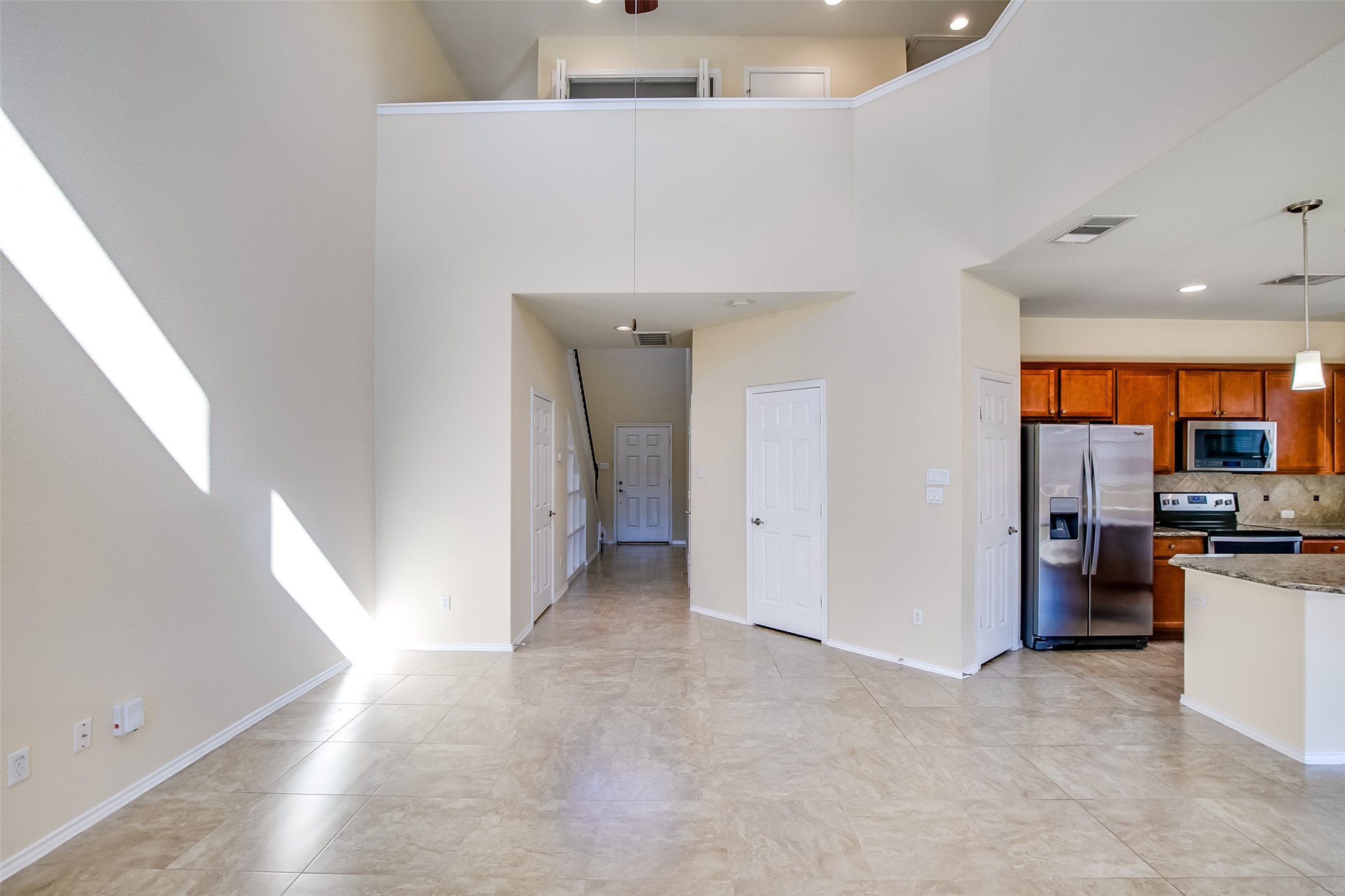 3717 Dover Ferry Crossing Austin, TX 78728 - Photo 7 of 29 a view of a kitchen with a sink and a refrigerator