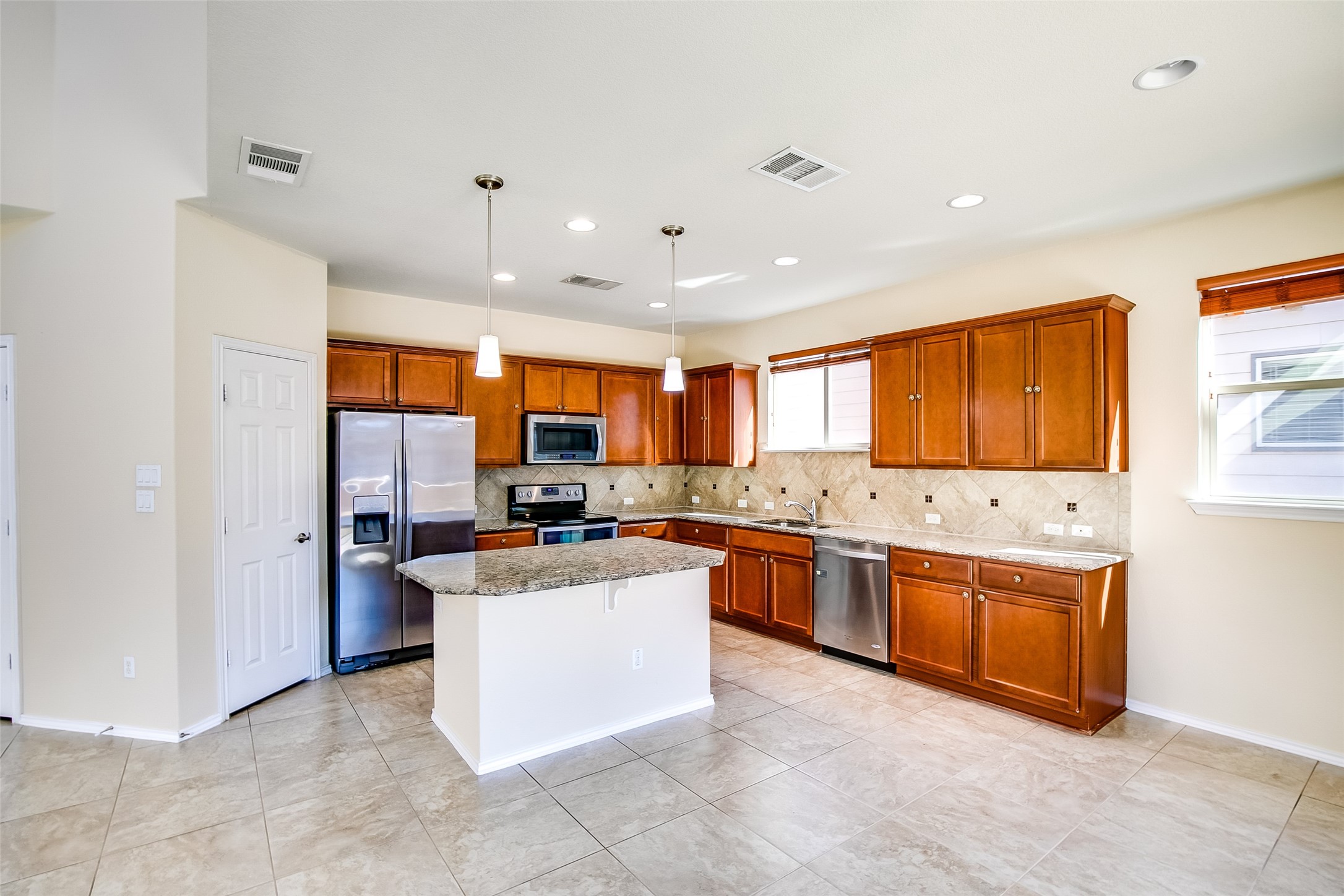 3717 Dover Ferry Crossing Austin, TX 78728 - Photo 9 of 29 a kitchen with stainless steel appliances granite countertop a stove oven and a refrigerator