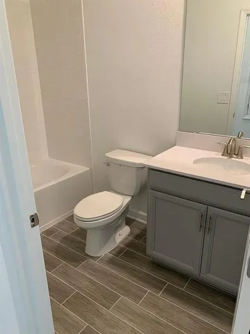 a bathroom with a toilet a sink and bathtub