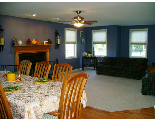 2 April Pepperell, MA 01463 - Photo 4 of 6 a living room with furniture a fireplace and a chandelier