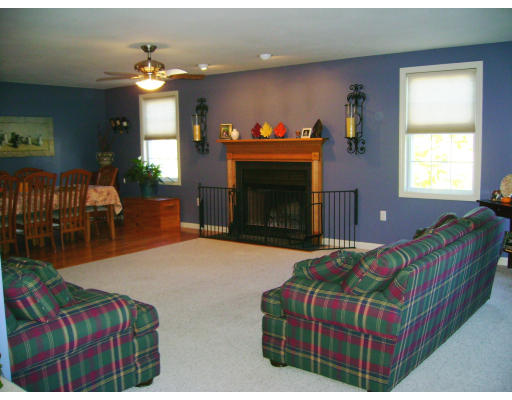2 April Pepperell, MA 01463 - Photo 6 of 6 a bedroom with a bed and a fireplace