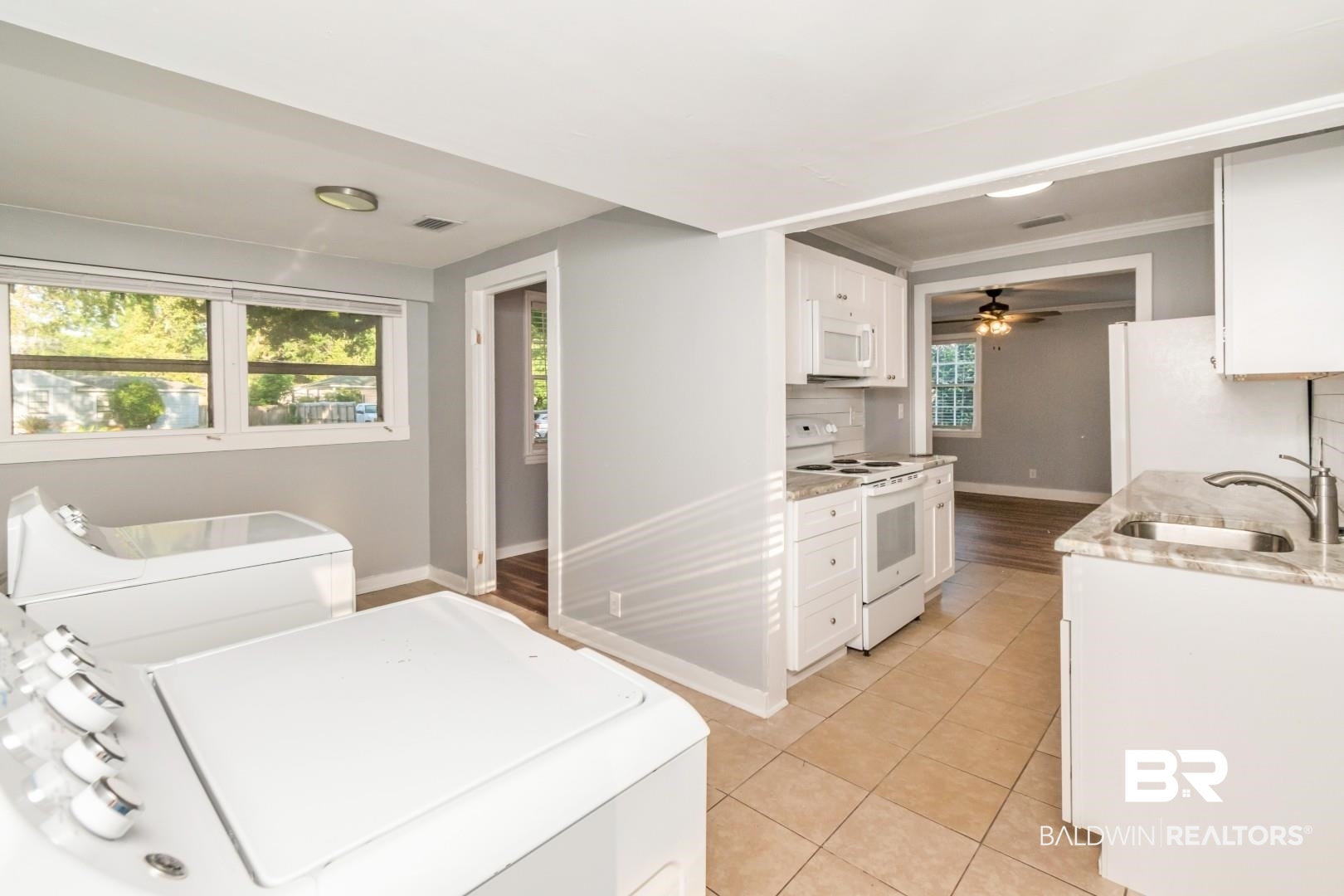 263 Border Drive East Mobile, AL 36608 - Photo 7 of 27 Kitchen featuring white cabinetry, light-toned countertops, and a white subway tile backsplash