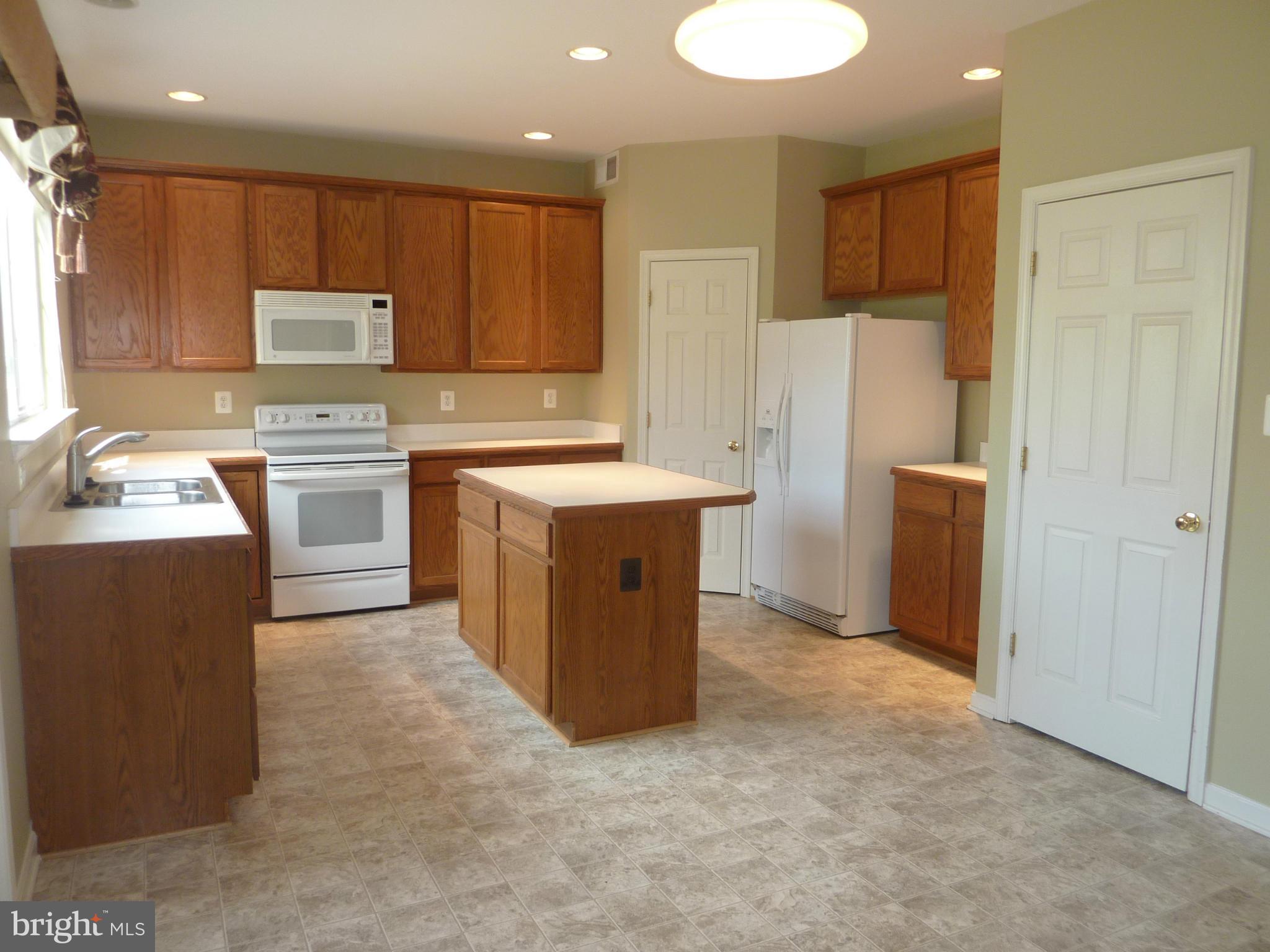 39 Hamstead Road Fredericksburg, VA 22405 - Photo 8 of 30 a kitchen with a refrigerator sink and cabinets