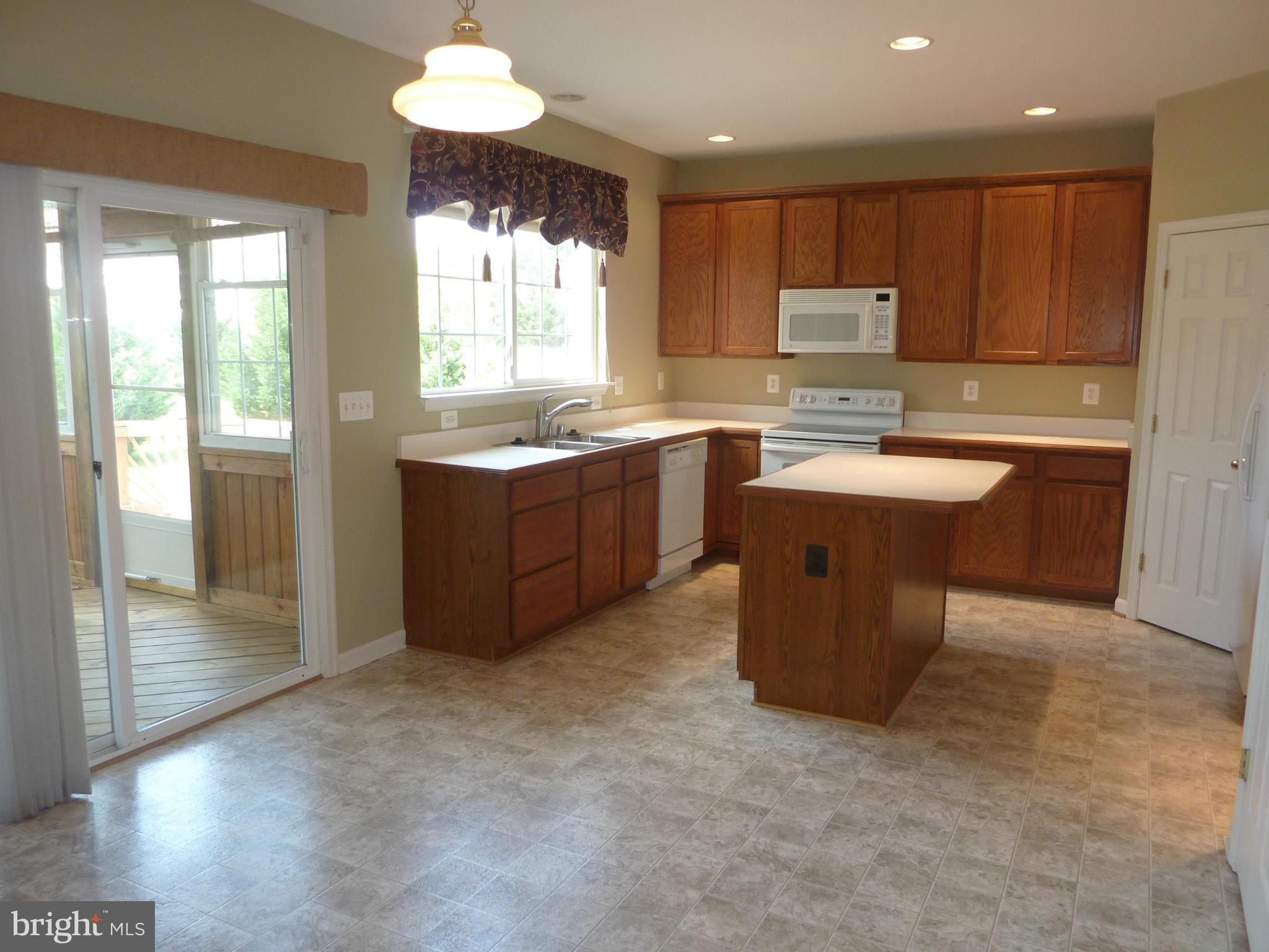 39 Hamstead Road Fredericksburg, VA 22405 - Photo 9 of 30 a kitchen with cabinets a sink a counter space and a window