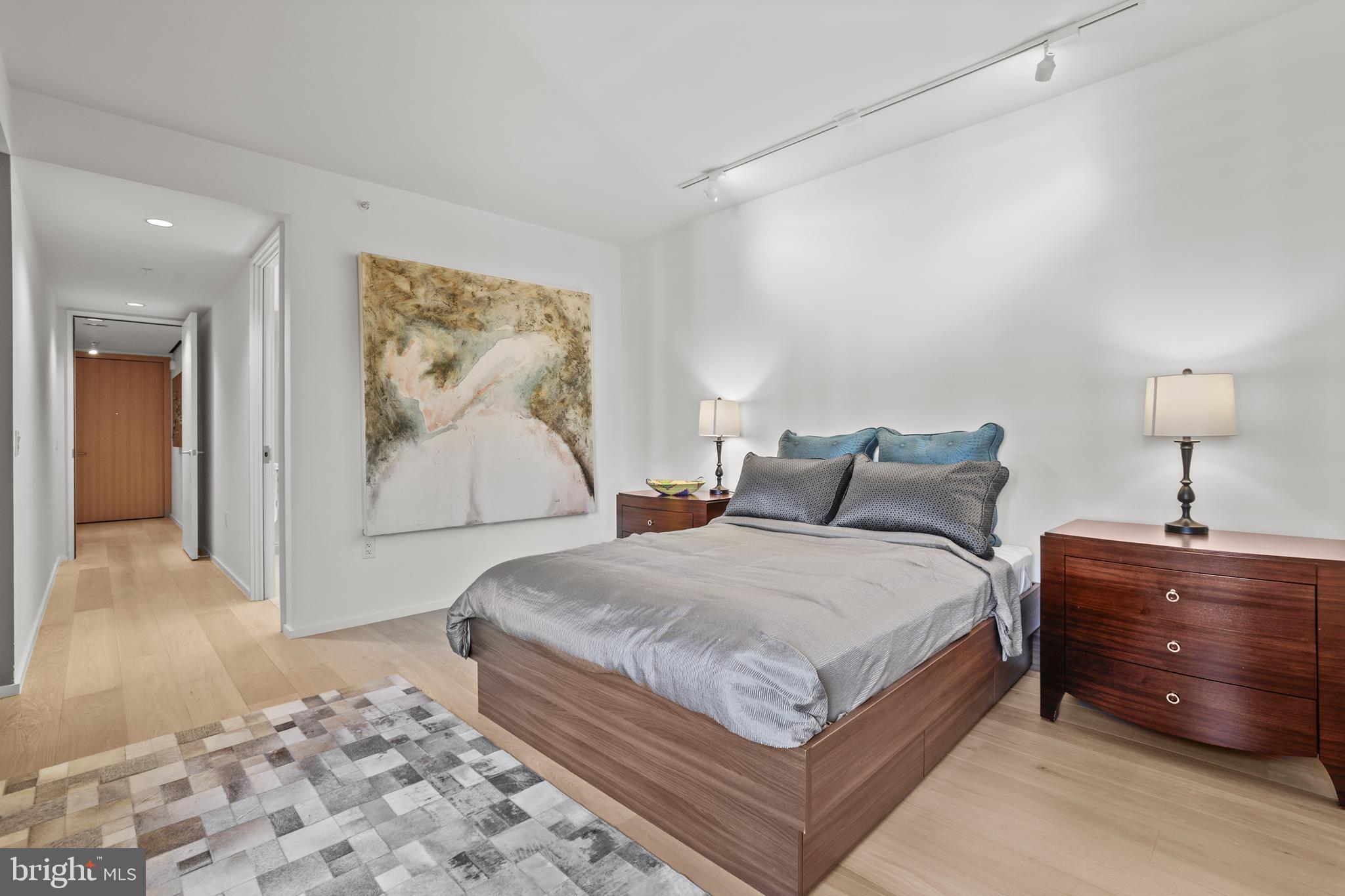 925 H Street Northwest, Unit 712 Washington, DC 20001 - Photo 15 of 54 a bedroom with a bed and a painting on the wall