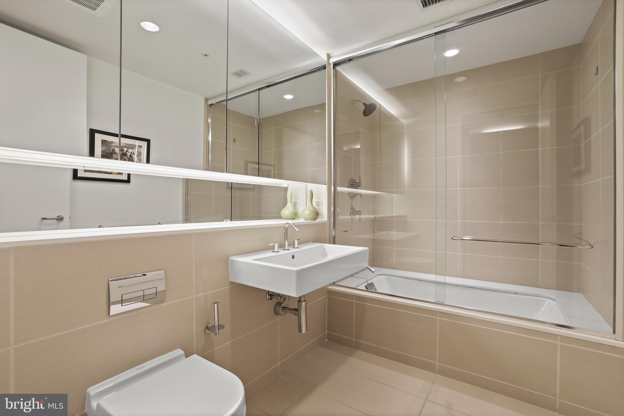 925 H Street Northwest, Unit 712 Washington, DC 20001 - Photo 22 of 54 a bathroom with a sink a toilet and shower