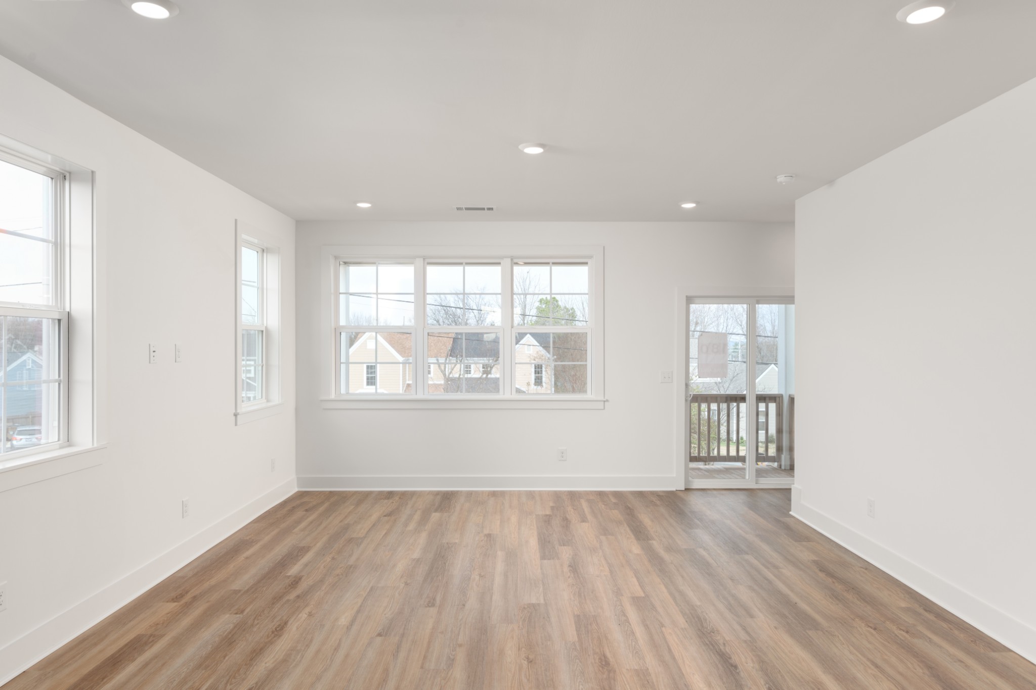 251 Nesbitt Lane Madison, TN 37115 - Photo 11 of 35 an empty room with wooden floor and windows