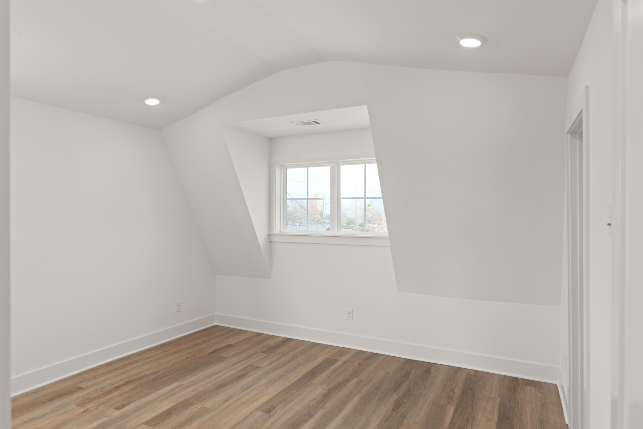 251 Nesbitt Lane Madison, TN 37115 - Photo 12 of 35 a view of an empty room with wooden floor and a window