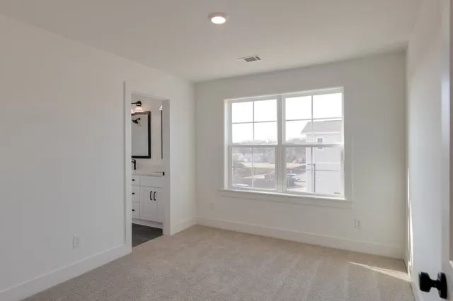 an empty room with windows and closet