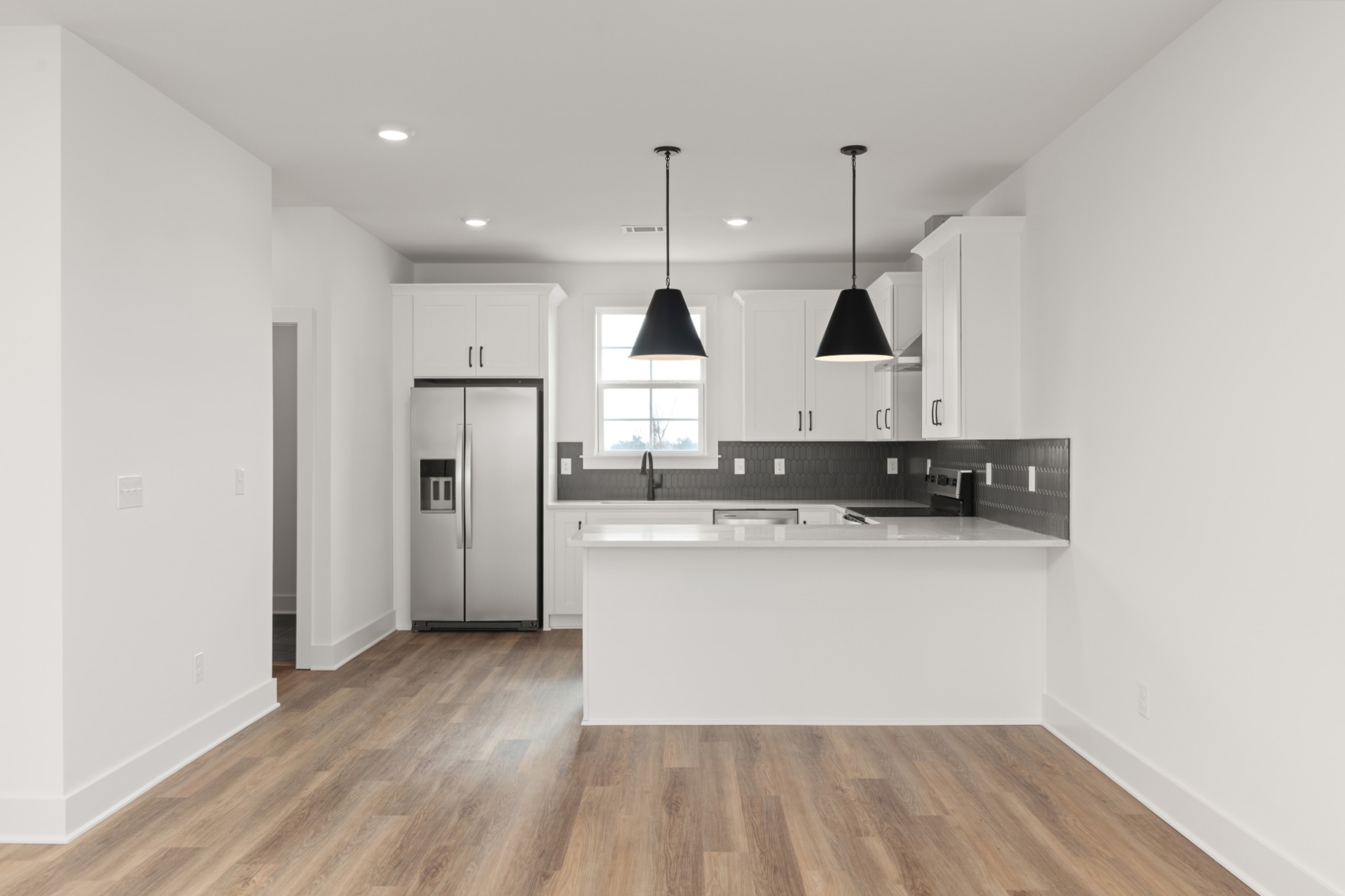 251 Nesbitt Lane Madison, TN 37115 - Photo 7 of 35 a kitchen with stainless steel appliances granite countertop a sink a stove a refrigerator and white cabinets with wooden floor