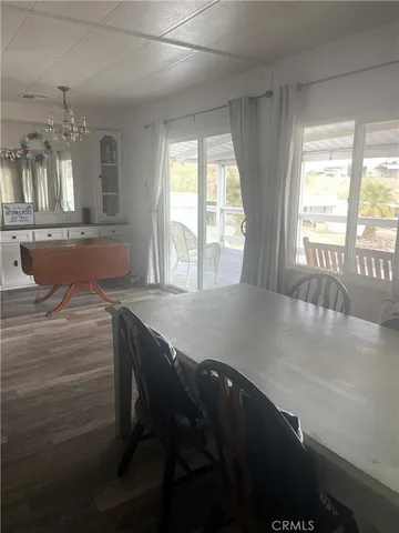 a view of a dining room with furniture and a large window