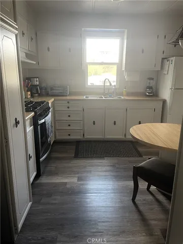 a kitchen with a sink appliances and cabinets