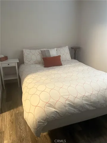 a bed sitting in a bedroom next to a lamp