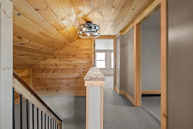 a bedroom with a large bed and a potted plant