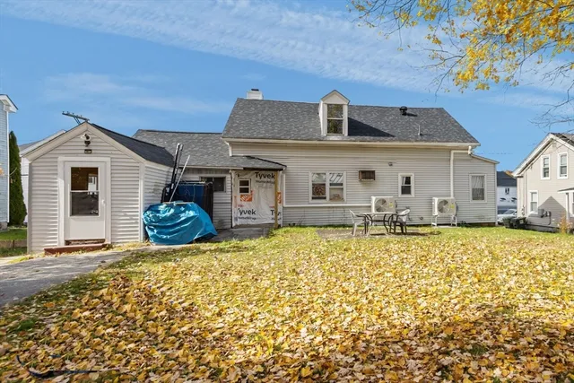a view of a house with pool and a yard