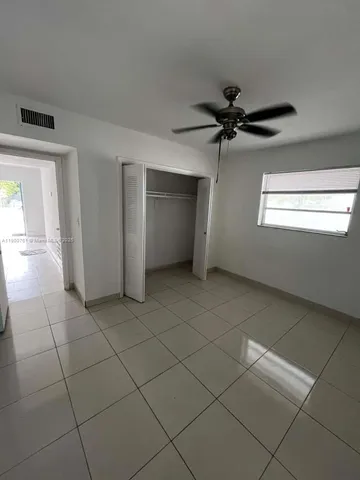 a view of a livingroom with a ceiling fan and window