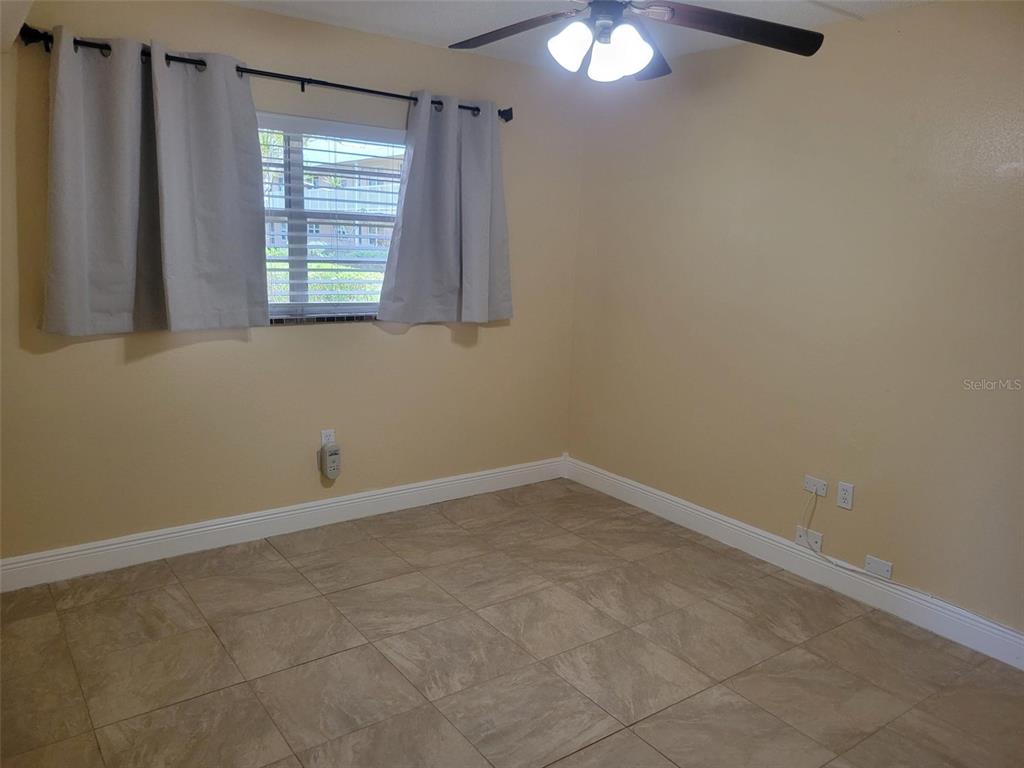 10032 65th Avenue North, Unit 8 St. Petersburg, FL 33708 - Photo 14 of 61 a view of an empty room with a window